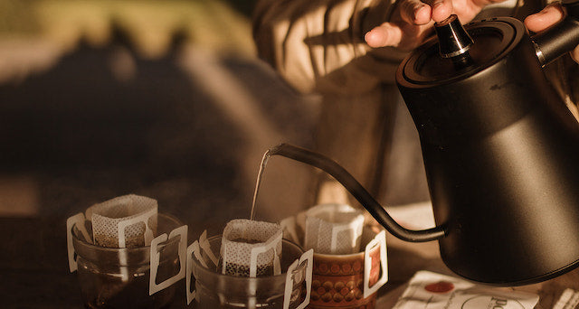 Pouring into a coffee drip bag with a kettle